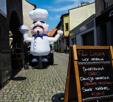 Hello Man as a chef inviting guests to a restaurant